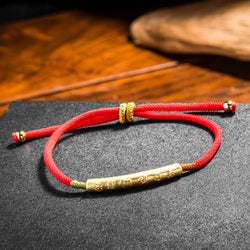 Bracelet tibétain en fil rouge – Porte-bonheur bouddhiste